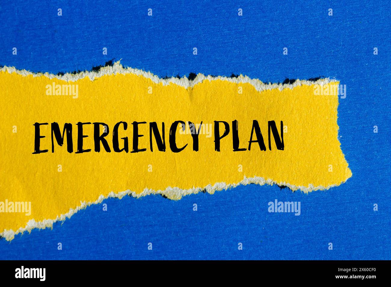 Emergency plan words written on ripped yellow paper with blue background. Conceptual emergency plan symbol. Copy space. Stock Photo