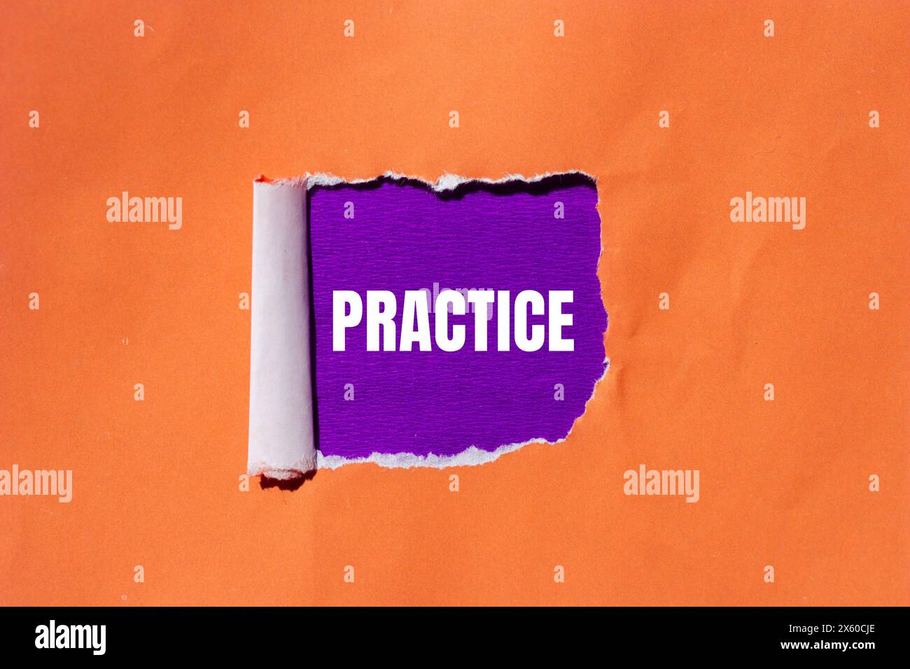 Practice word written on ripped orange paper with purple background ...