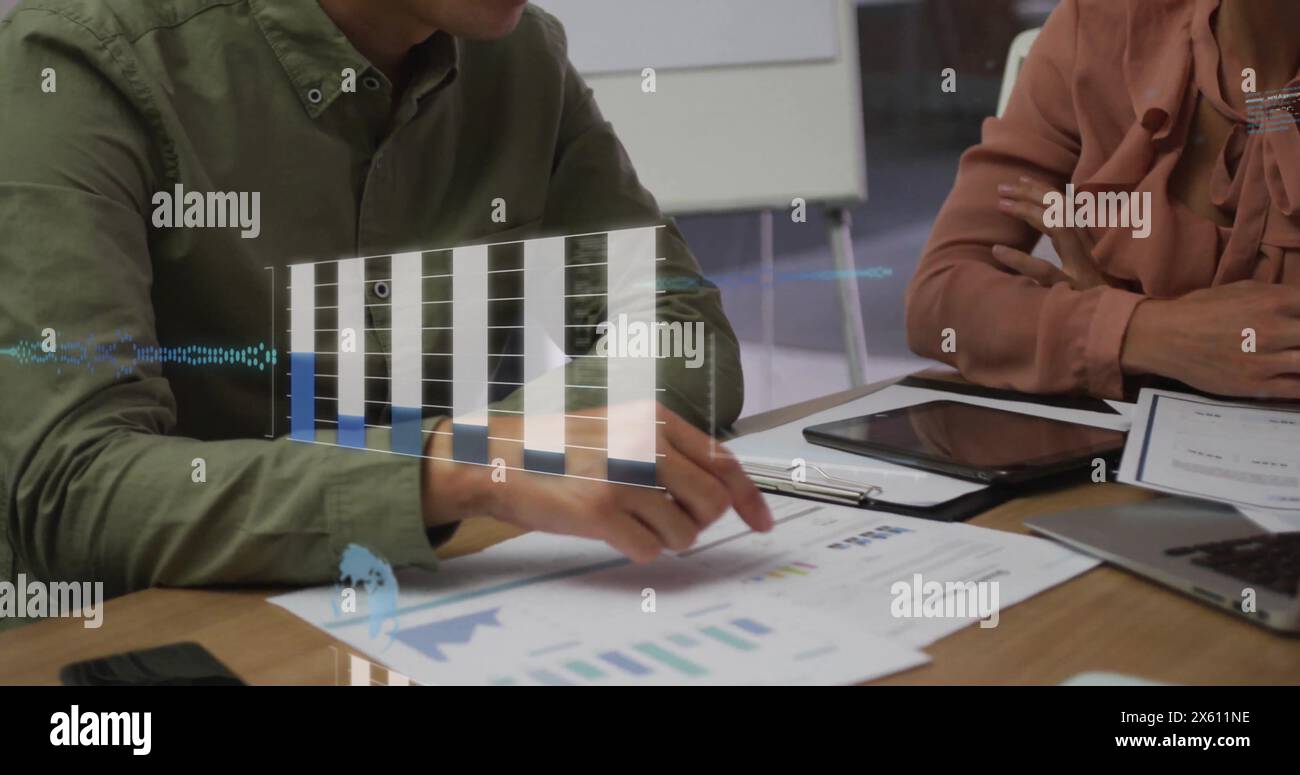 Image of graphs, globe, computer language over diverse colleagues analyzing report in office Stock Photo