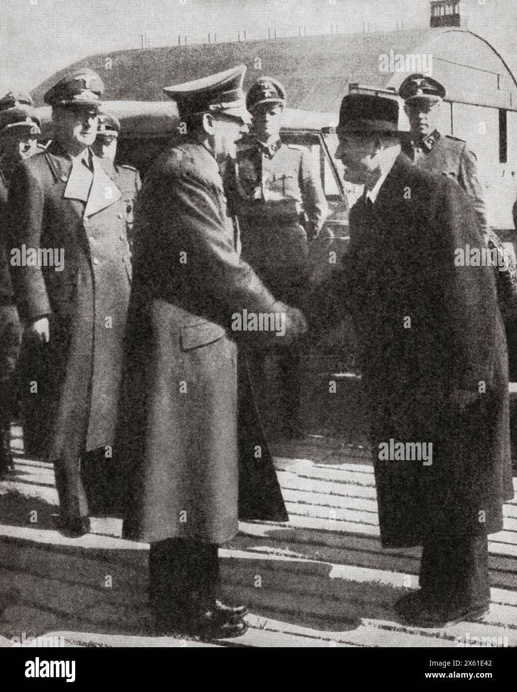 Mussolini saying goodbye to Hitler before returning to Italy after being freed from prison by Nazi paratroops in September, 1943.  Adolf Hitler, 1889 – 1945. German politician, demagogue, Pan-German revolutionary, leader of the Nazi Party, Chancellor of Germany, and Führer of Nazi Germany from 1934 to 1945. Benito Amilcare Andrea Mussolini, 1883 – 1945. Italian dictator, journalist, founder and leader of the National Fascist Party (PNF), and Prime Minister of Italy. From The War in Pictures, Fifth Year. Stock Photo
