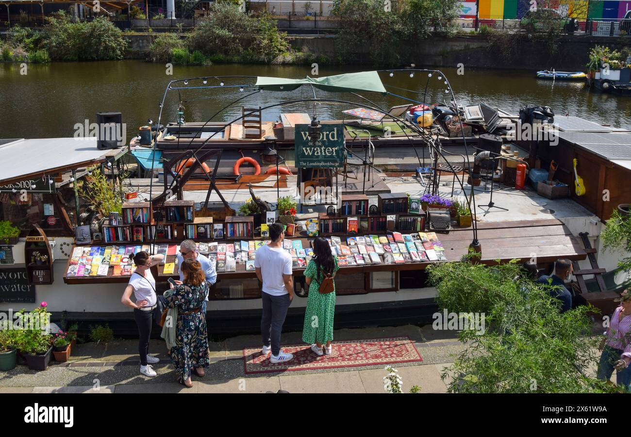 London, UK. 12th May 2024. Customers browse the selection at the Word On The Water barge bookshop on Regent's Canal in King's Cross, as the UK records the hottest day of the year so far. Credit: Vuk Valcic/Alamy Live News Stock Photo