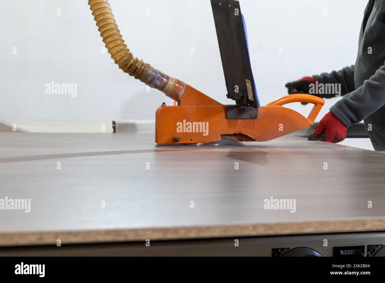 Furniture manufacture. Cutting wood panels on circular saw in