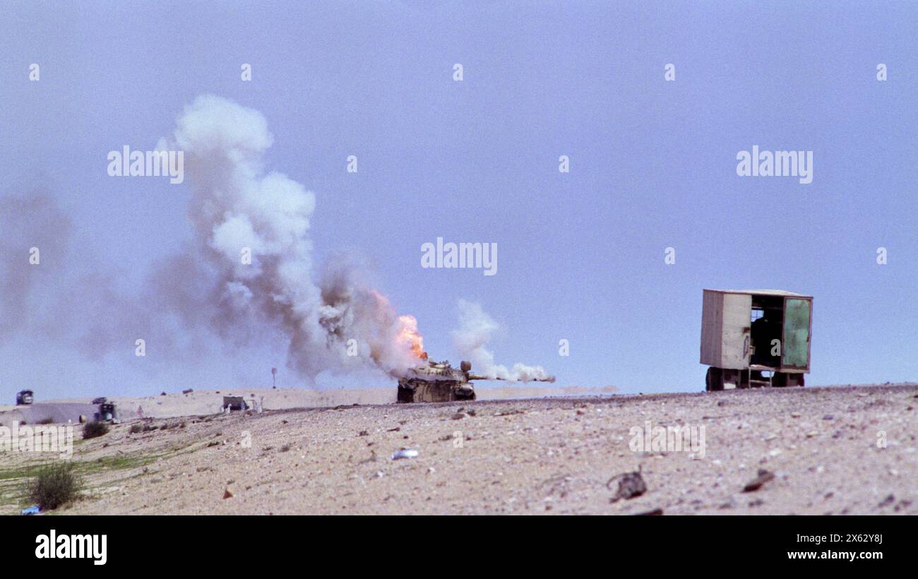 5th March 1991 An abandoned Iraqi T55 tank spews smoke and flame as it burns on Route 801, the road to Um Qasr, north of Kuwait City. Stock Photo