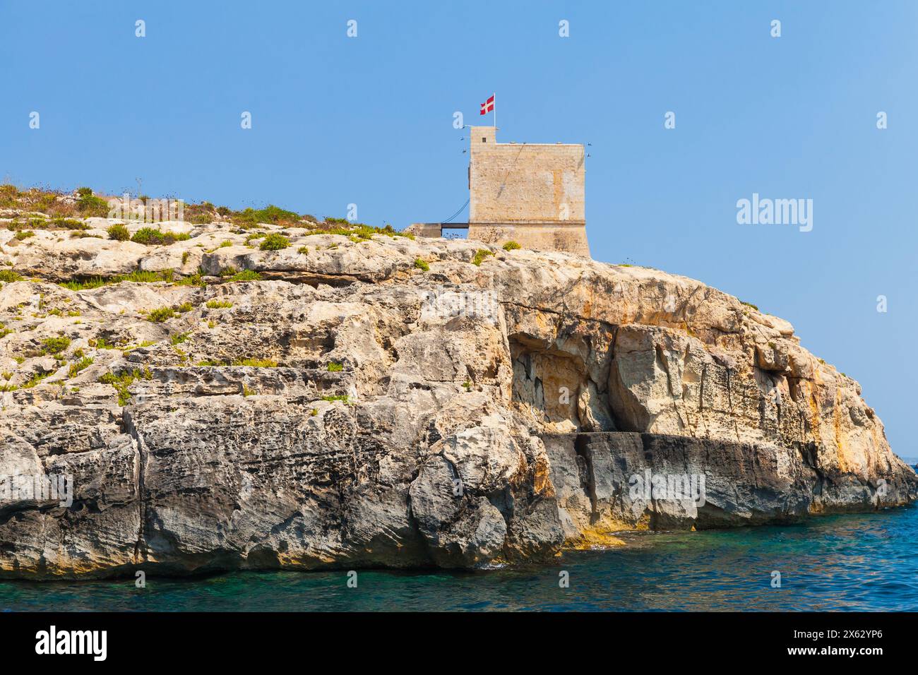 Seaside landscape with Mgarr ix-Xini Tower, the largest of the coastal watchtowers that the Knights of Malta erected on the island of Gozo Stock Photo