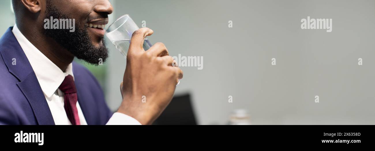 Unrecognizable black businessman drinking water, copy space Stock Photo