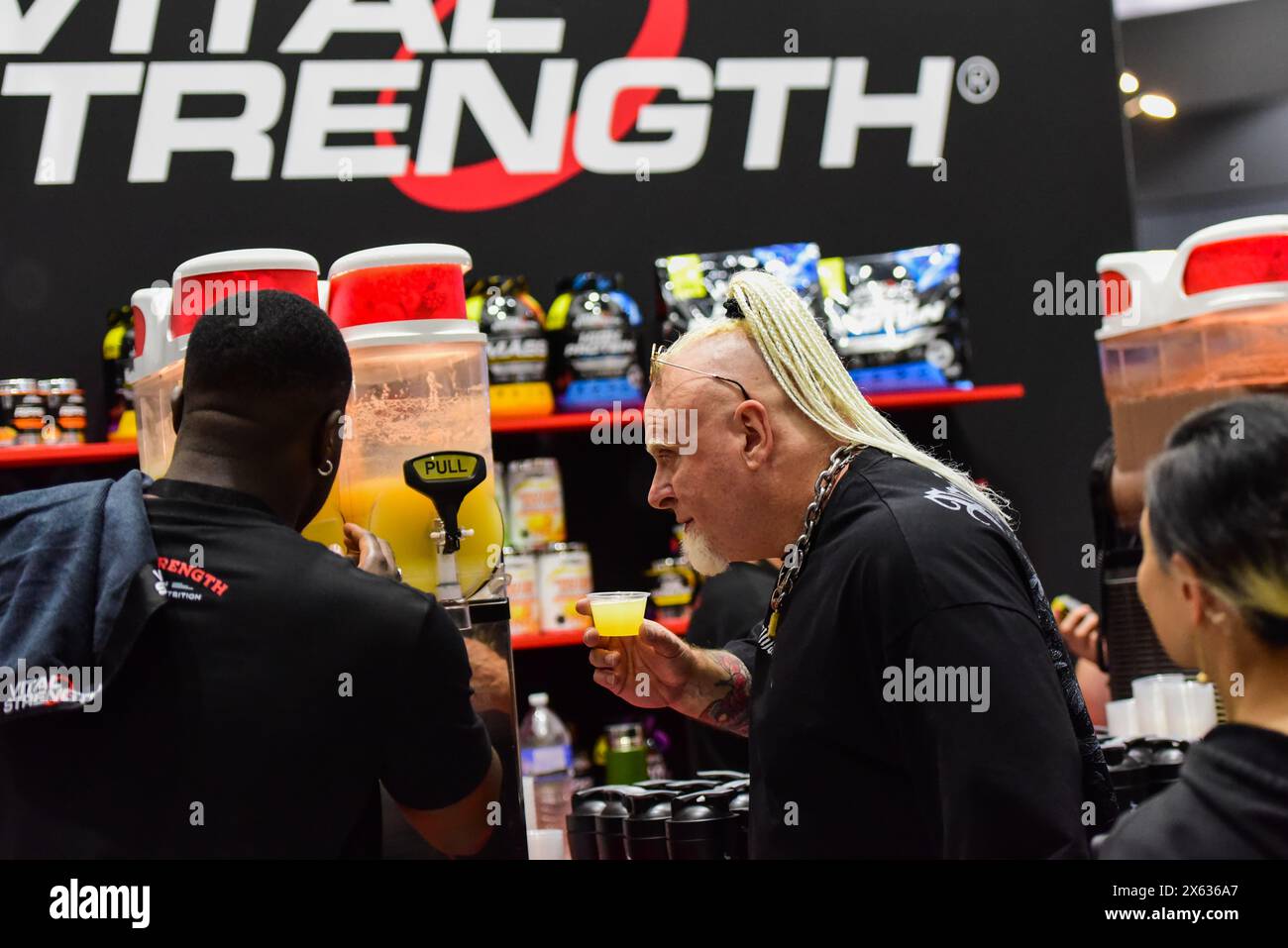 Visitors are seen trying samples at Vital Strength stall at the