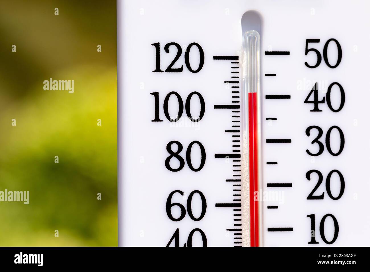 Outdoor thermometer in the sun during heatwave. Hot weather, high temperature and heat warning concept. Stock Photo