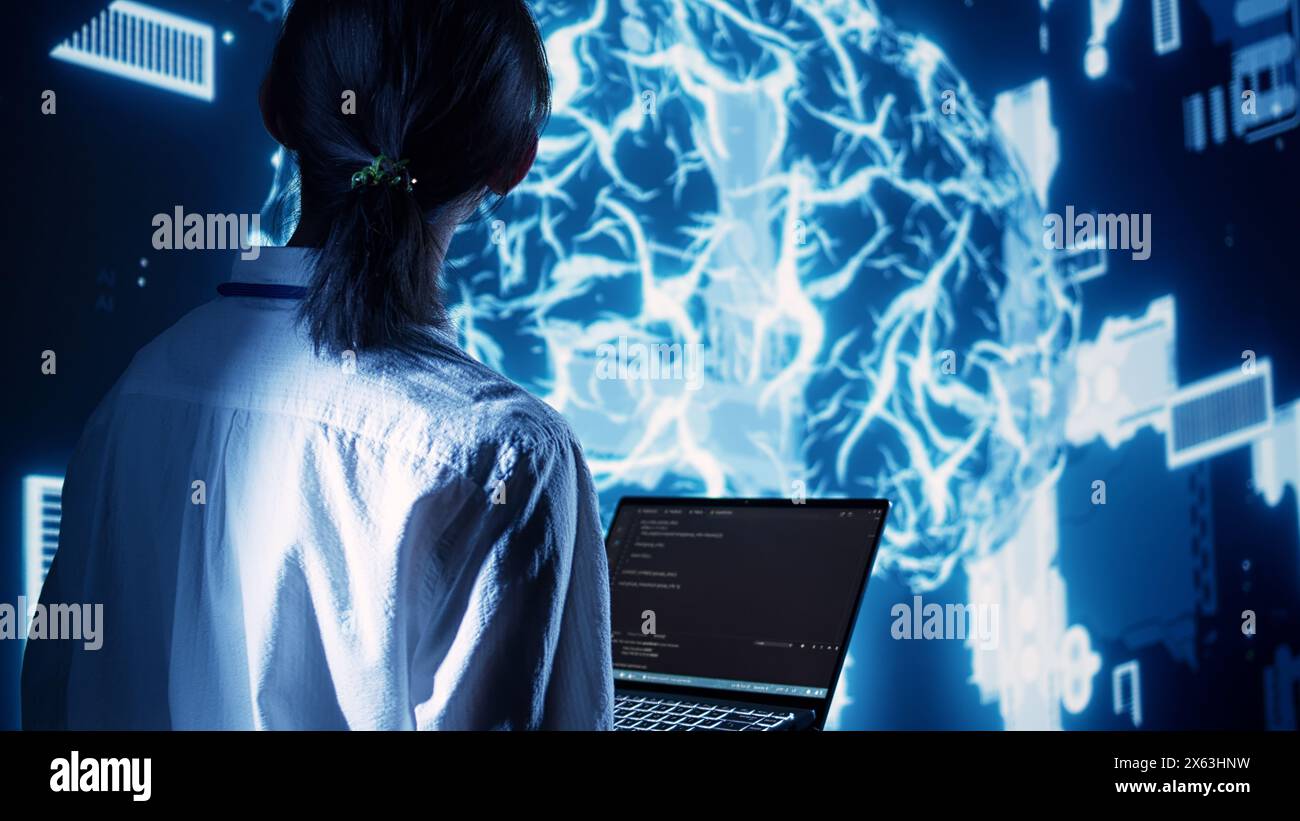 Competent manager in data center running programming scripts on laptop, solving tasks. Licensed specialist manipulating lines of code for artificial intelligence applications development Stock Photo