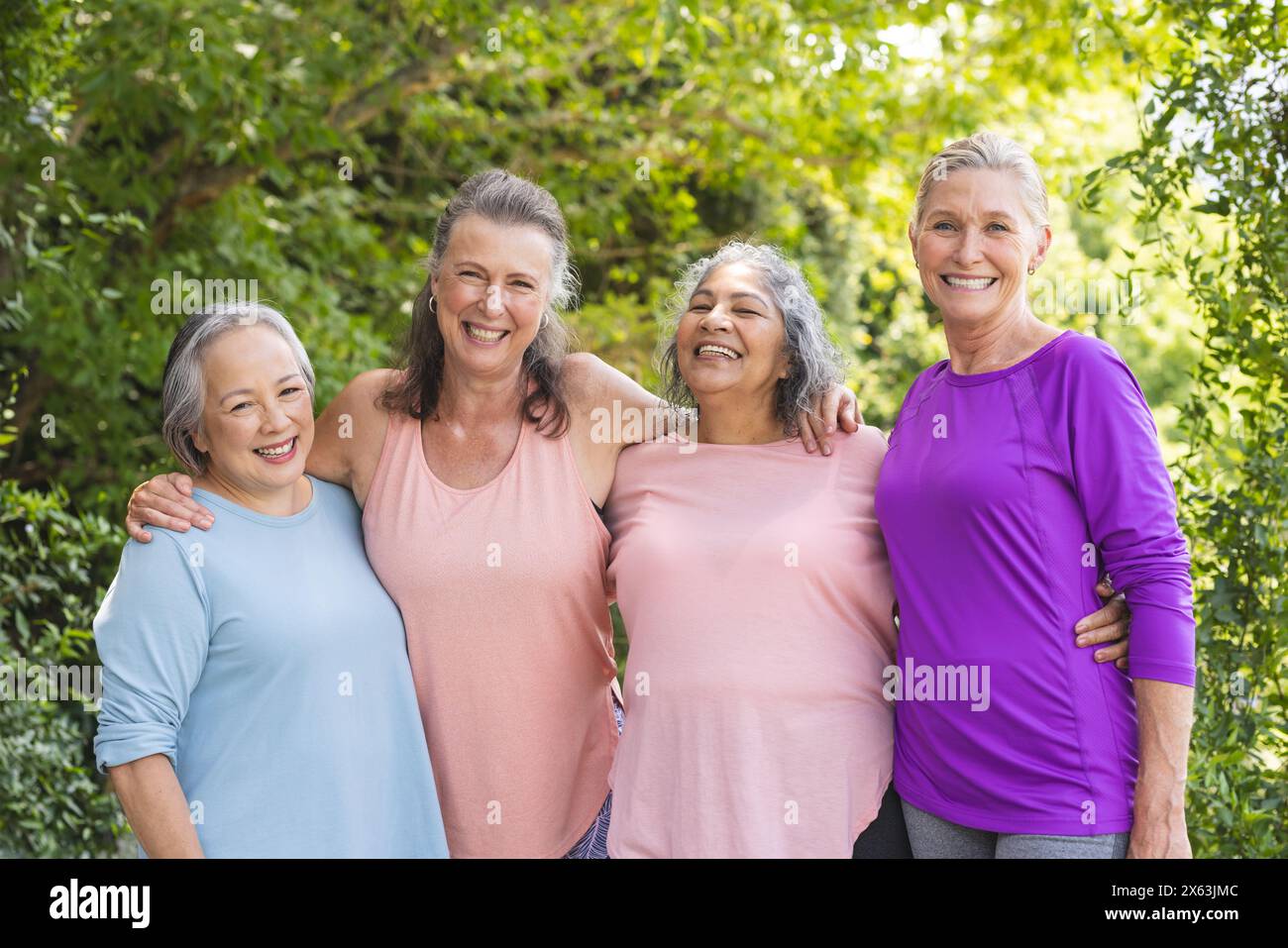 Outdoors, senior female friends standing together, sharing smiles Stock ...