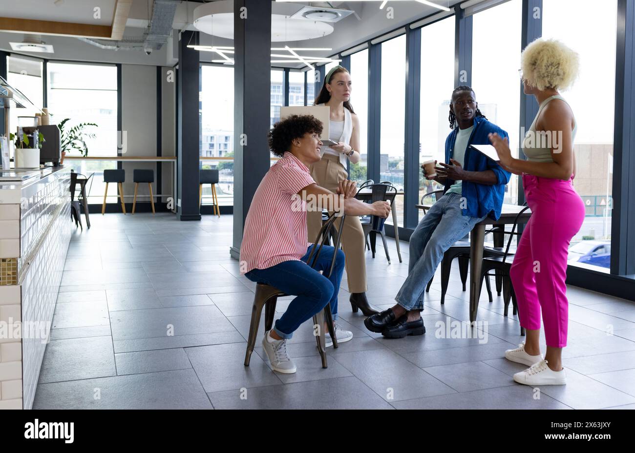 In modern office, diverse young team discussing Stock Photo