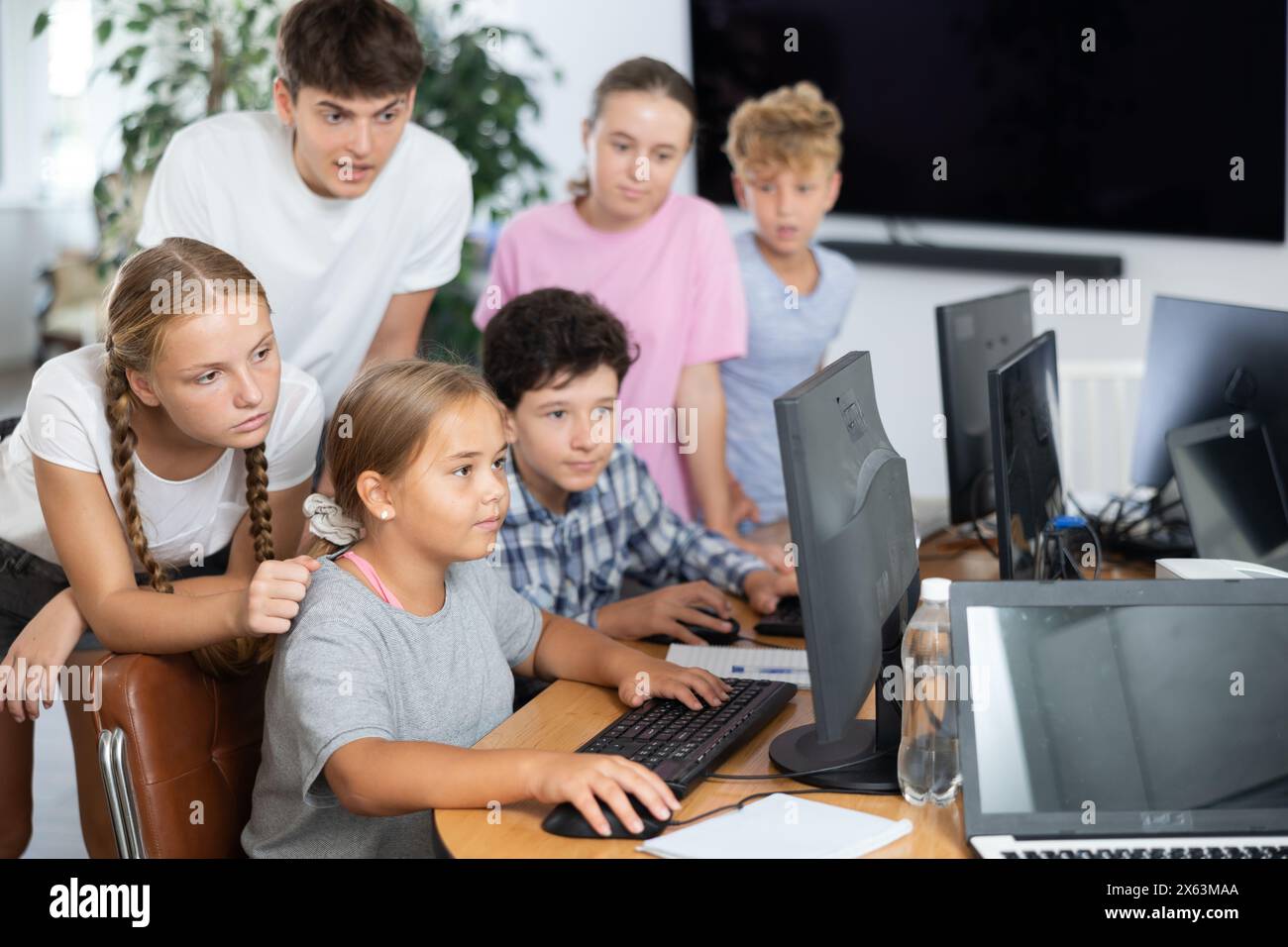 Computer lesson in classroom - classmates solve problems on computer ...