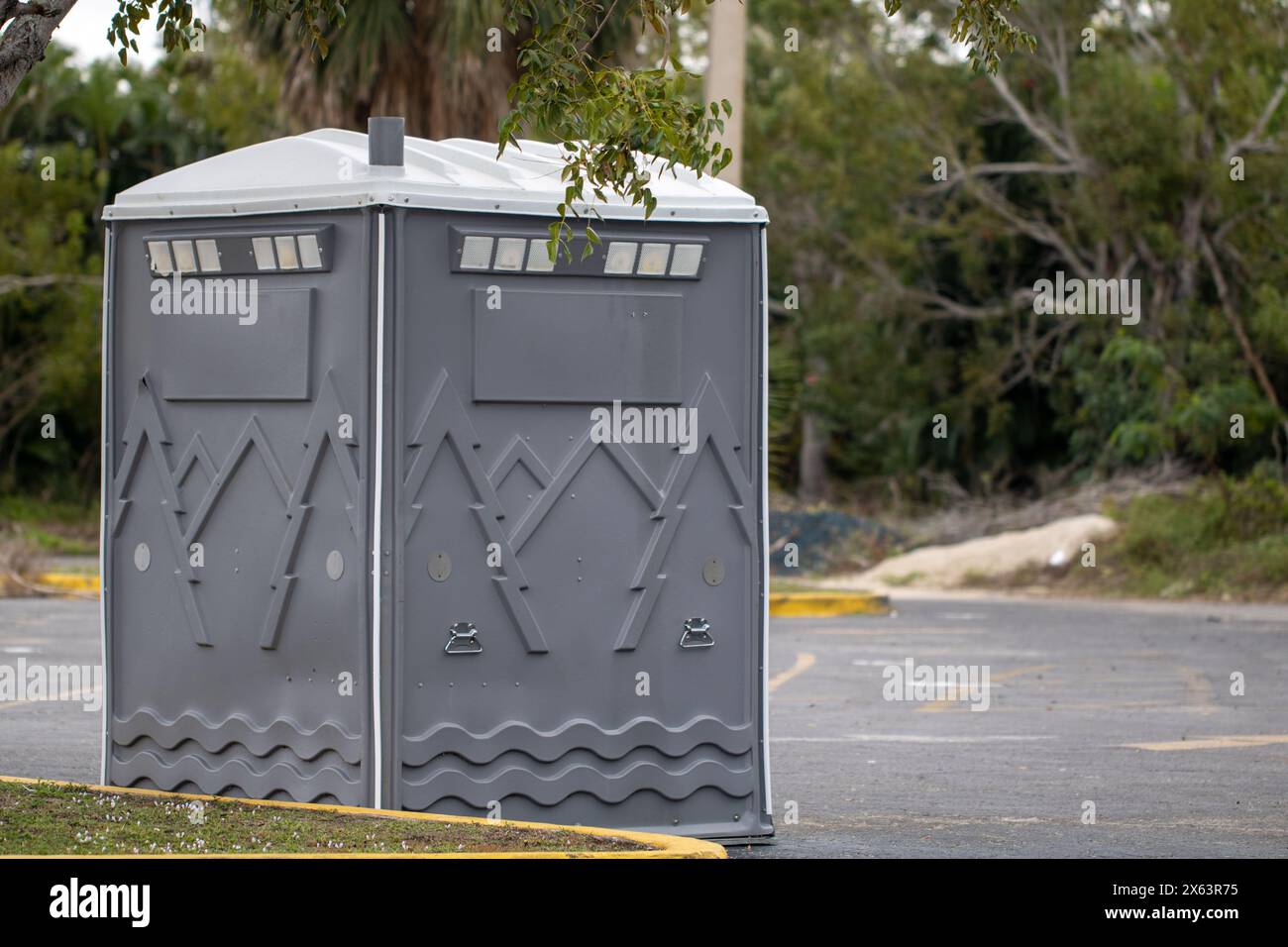 Single Big Port a Potty in a parking lot Stock Photo