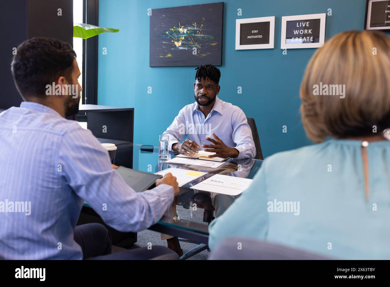 Diverse team discussing business in modern office Stock Photo