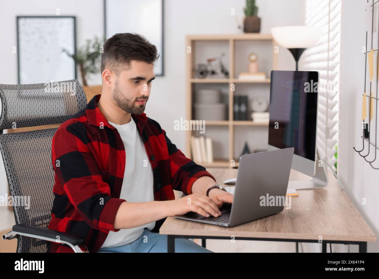 Young programmer working with laptop in office Stock Photo