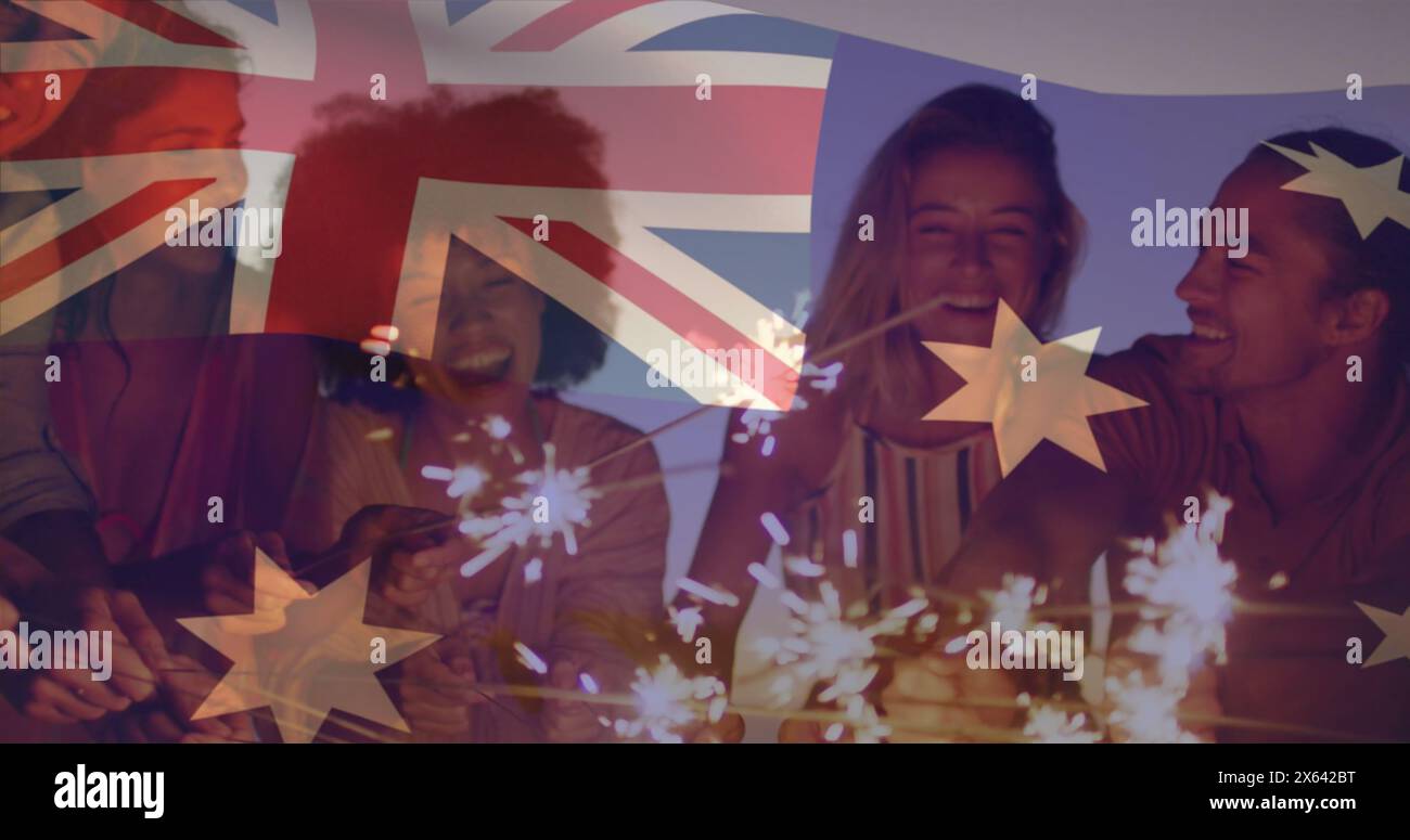 Composite image of australia flag over group of diverse friends celebrating with sparklers at beach Stock Photo
