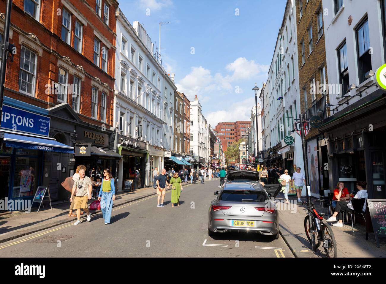 Old Compton street in Soho London, street scene London,Old Compton street has many gay bars and clubs shops,Central London,England,UK,2023 Stock Photo