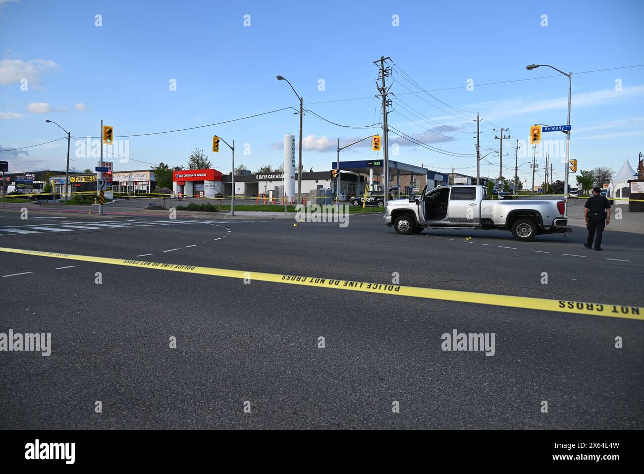 Police block off roads with crime scene tape to investigate a shooting that left one person injured in Scarborough. At approximately 4:54 p.m., Sunday afternoon police responded to the area of Kennedy Rd and Munham Gate for a driver shooting from a vehicle to a tow truck. Toronto police say that they located a victim suffering from gunshot wounds, the victim was transported to the hospital with non-life-threatening injuries. Police are actively searching for a suspect. This is the third shooting in the District of Scarborough involving a tow truck in less than 24 hours. (Photo by Kyle Mazza / Stock Photo