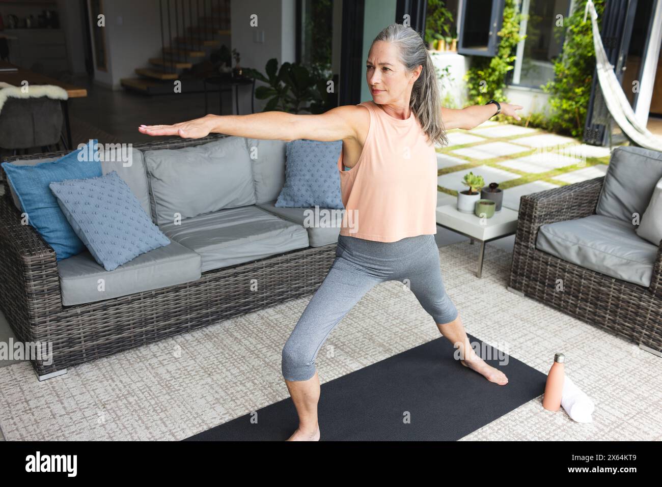 At home, mature Caucasian woman practicing yoga Stock Photo