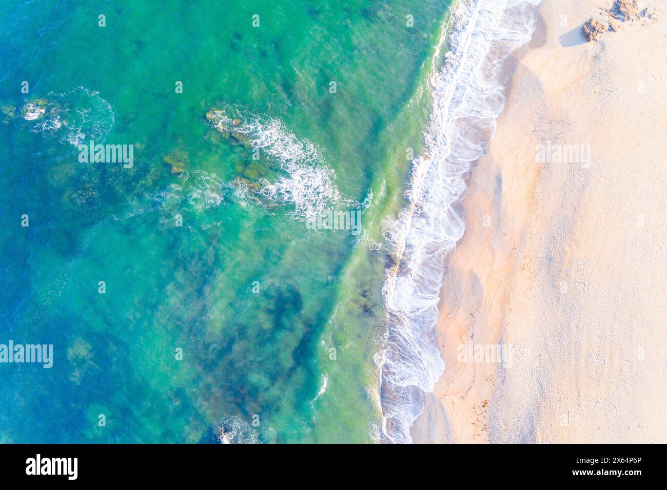 shore of an empty beach at dawn, turquoise water. Aerial top view with drone Stock Photo