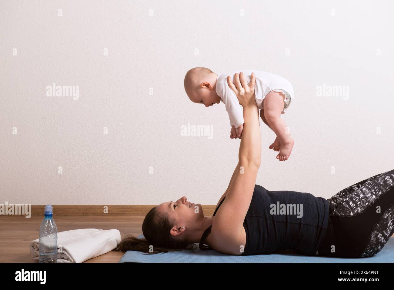 Home exercise for mother and baby, mommy and me workout. Using the baby