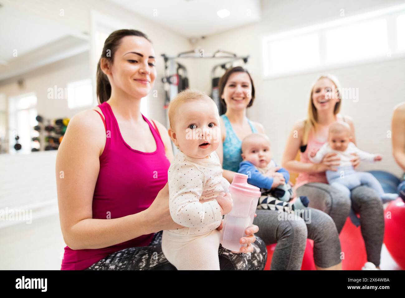 Baby movement class. Parents helping babies to improve motor skills