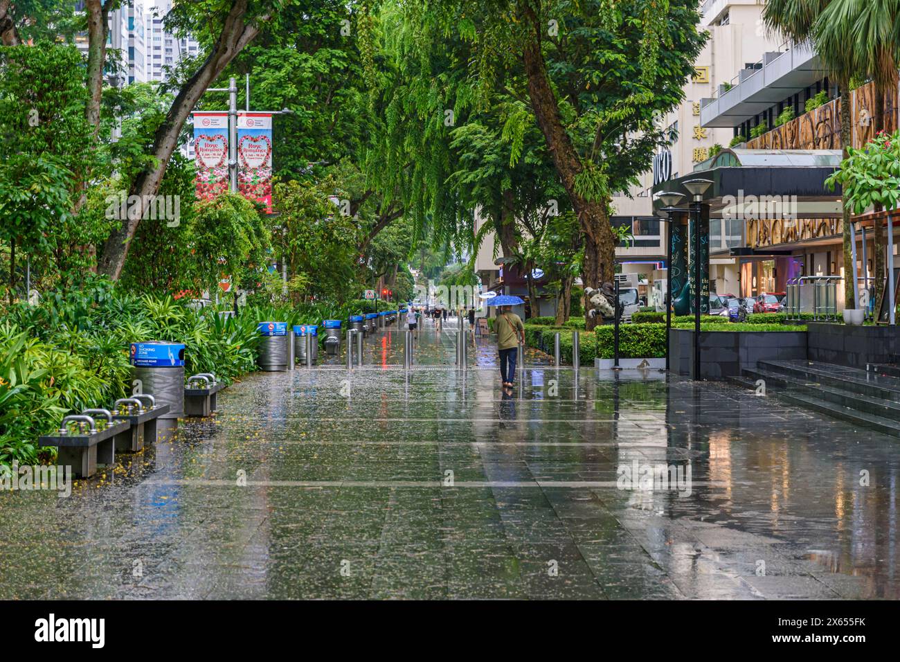 Wet rainy day along the shopping strip of Orchard Rd in Singapore Stock Photo