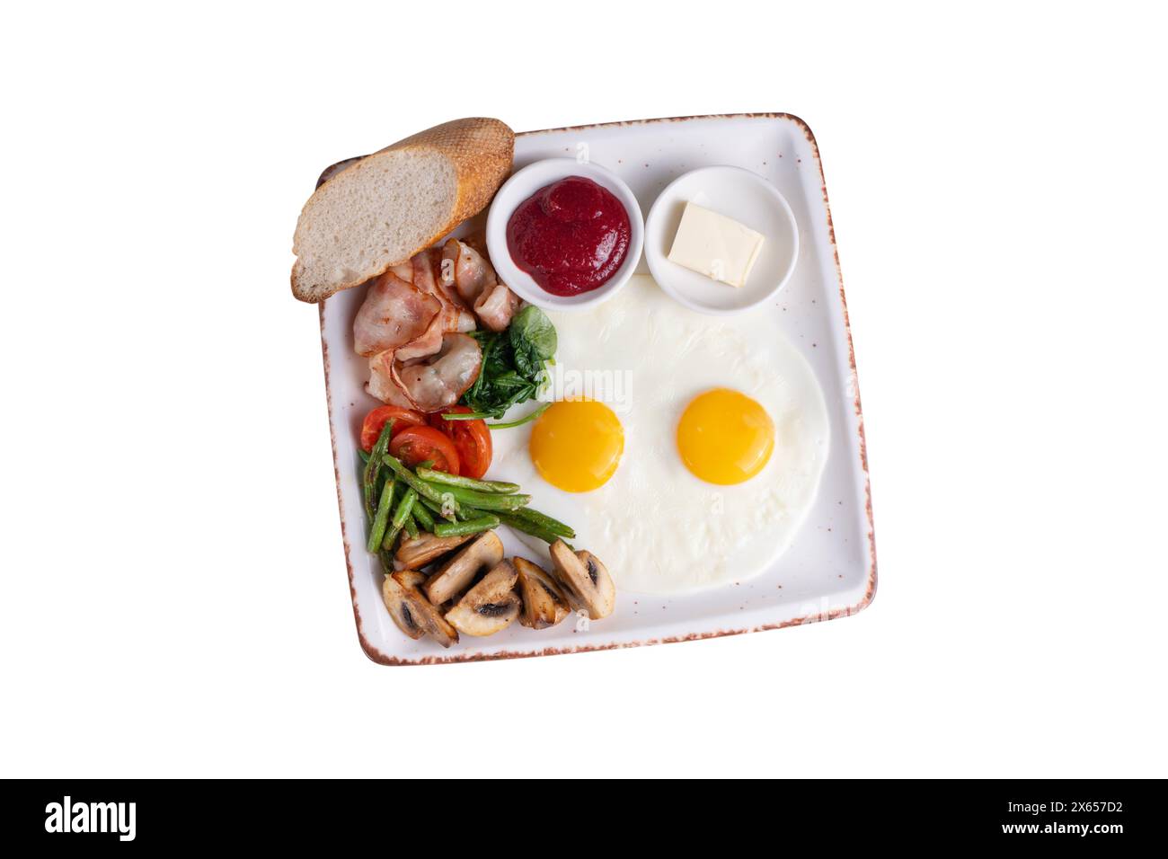 Breakfast Plate, Fried Eggs, Bacon, Roasted Mushrooms, Vegetables and Toppings on White Background Isolated Stock Photo