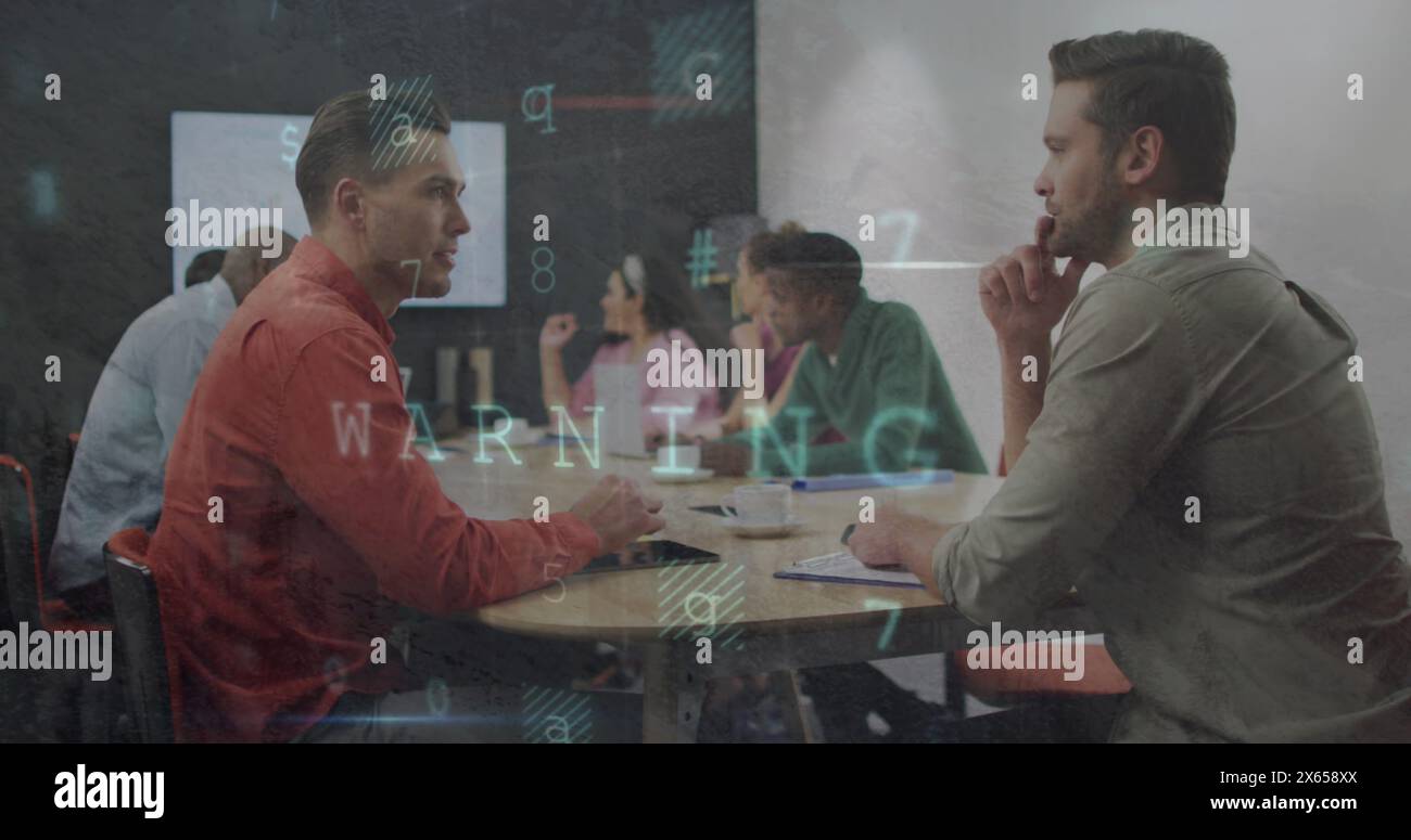 Diverse colleagues discussing at table, using laptops Stock Photo