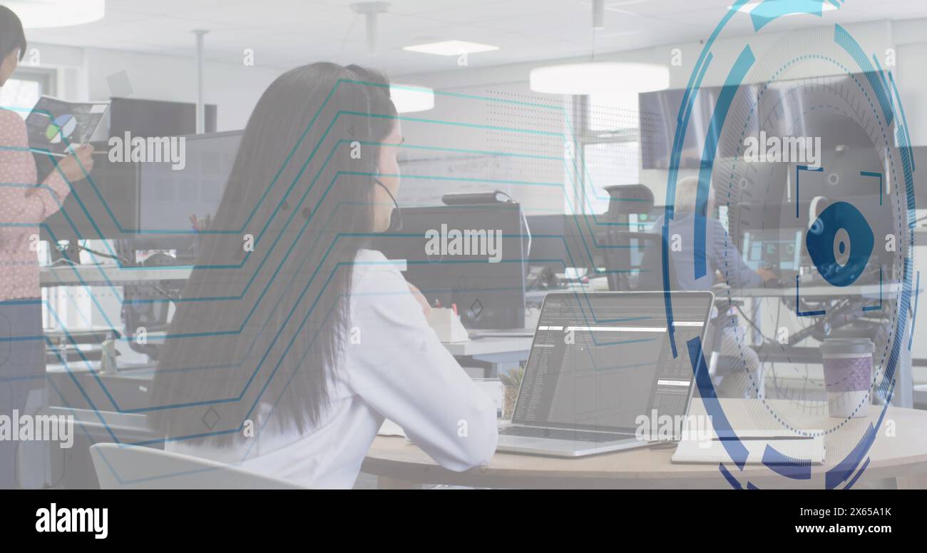 Image of eye over caucasian woman learning coding by watching online classes on laptop Stock Photo