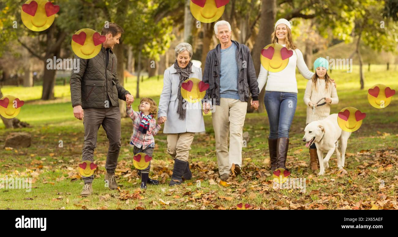 Caucasian family walking in park, including five members and dog Stock Photo