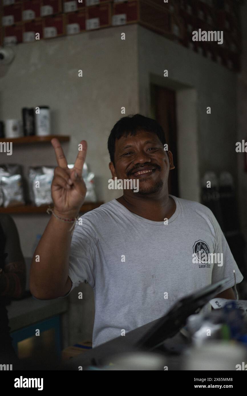 Cheerful smiling Indonesian man showing the peace Stock Photo