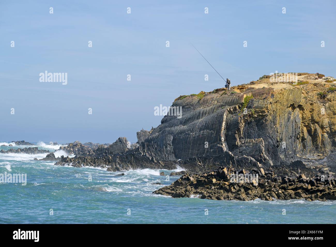 Angler fishing from clifftop, Costa Vicentina Natural Park, Alentejo, Portugal. Stock Photo