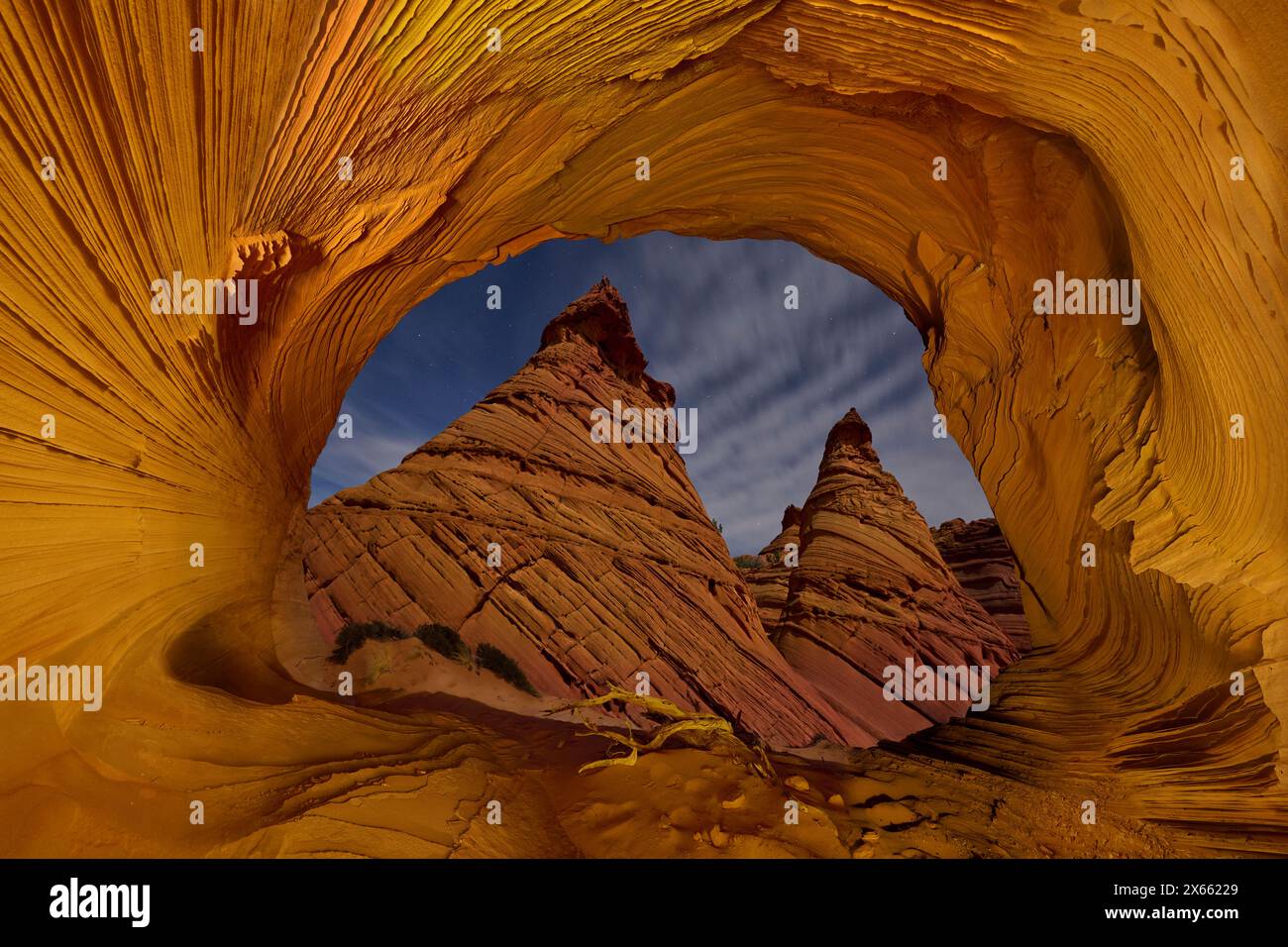 Hoodoos illuminated at night, seen from within an alcove in Ariz Stock Photo