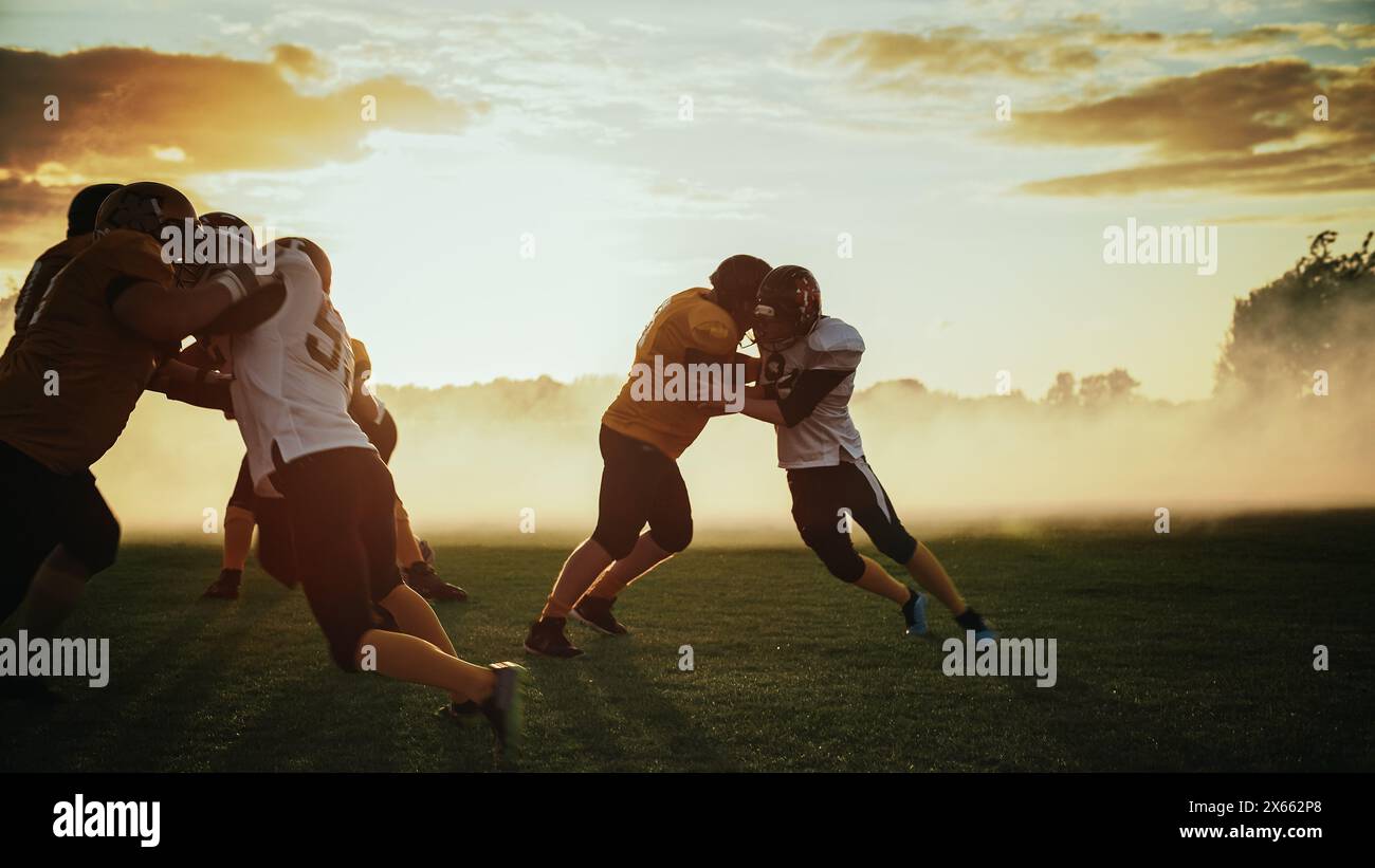 American Football Field Two Teams Compete: Players Pass and Run Attacking to Score Touchdown Points. Professional Athletes Fight for the Ball, Tackle. Golden Hour Sunset Stock Photo