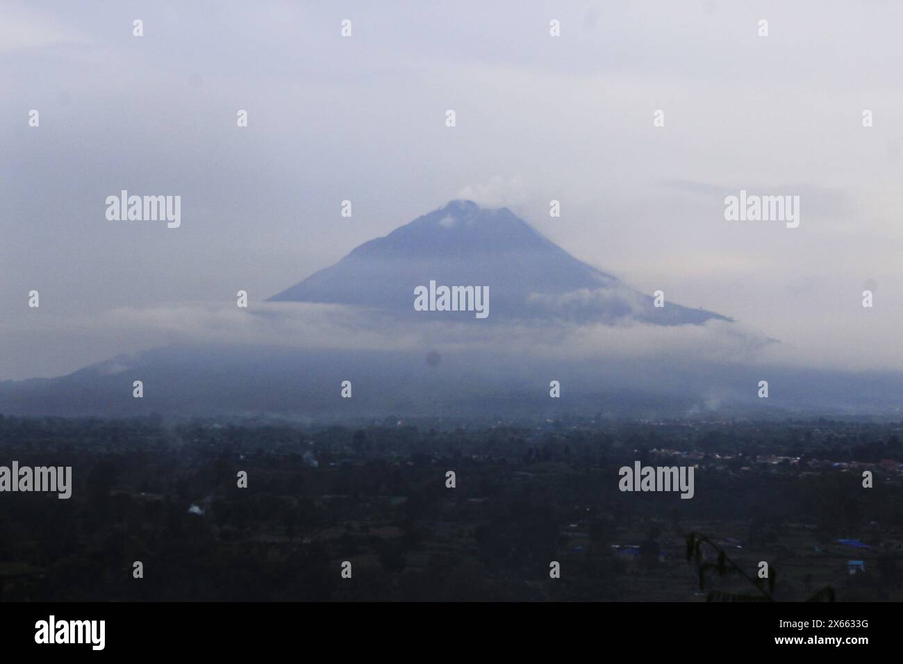Berastagi, North Sumatera, Indonesia. 13th May, 2024. Sinabung Volcano in North Sumatra, Indonesia, looks like fog during bad weather, and heavy rain is expected around it, May 13 2024 (Credit Image: © Kartik Byma/ZUMA Press Wire) EDITORIAL USAGE ONLY! Not for Commercial USAGE! Stock Photo