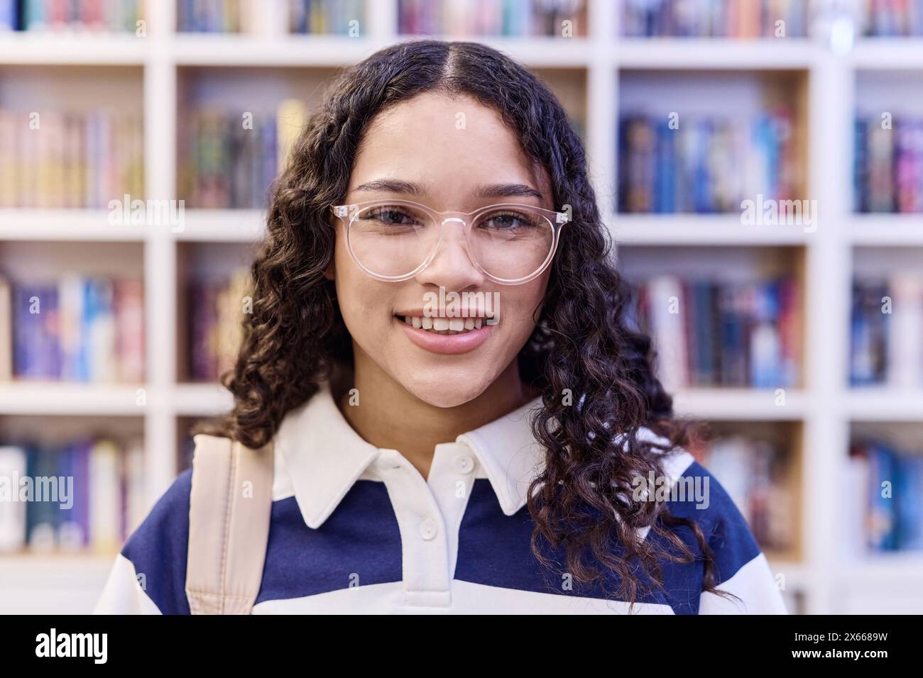 Close up portrait of teenage girl wearing glasses looking at camera in ...