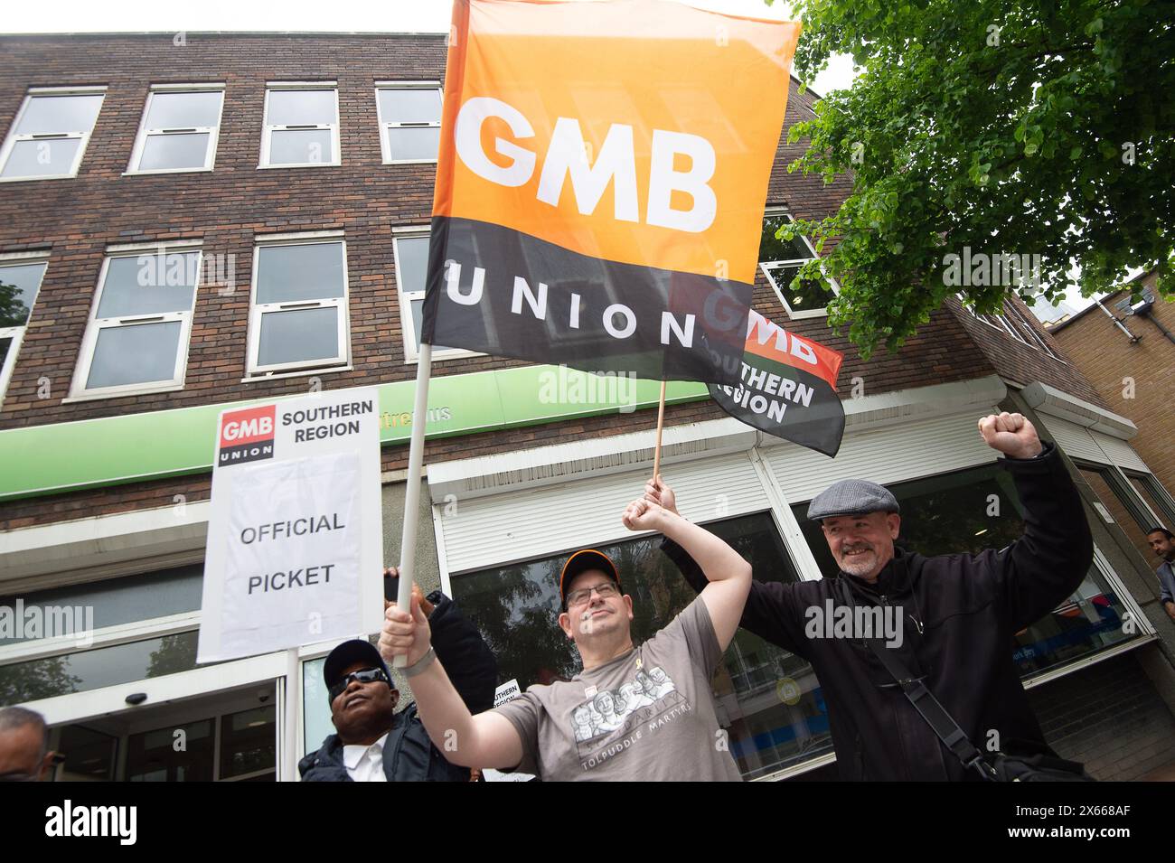 Slough, UK. 13th May, 2024. Security guards were on strike today outside the Job Centre Plus in Slough, Berkshire. They are holding a 24 hour strike in a dispute over their pay rates. GMB said more than 1,000 of its members employed by G4S will walk out today with further strike action planned for later this month. A survey of GMB members found four out of five had experienced abuse in their jobs, including being attacked by dogs and punched by members of the public. Many described daily verbal abuse, including threats to their families, racist abuse and death threats. GMB national officer Eam Stock Photo