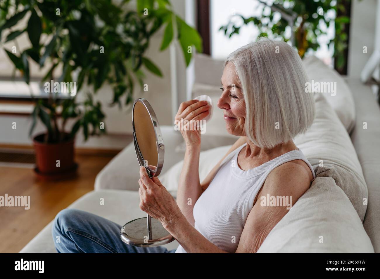 Skincare for mature woman. Portrait of beautiful older woman with gray ...