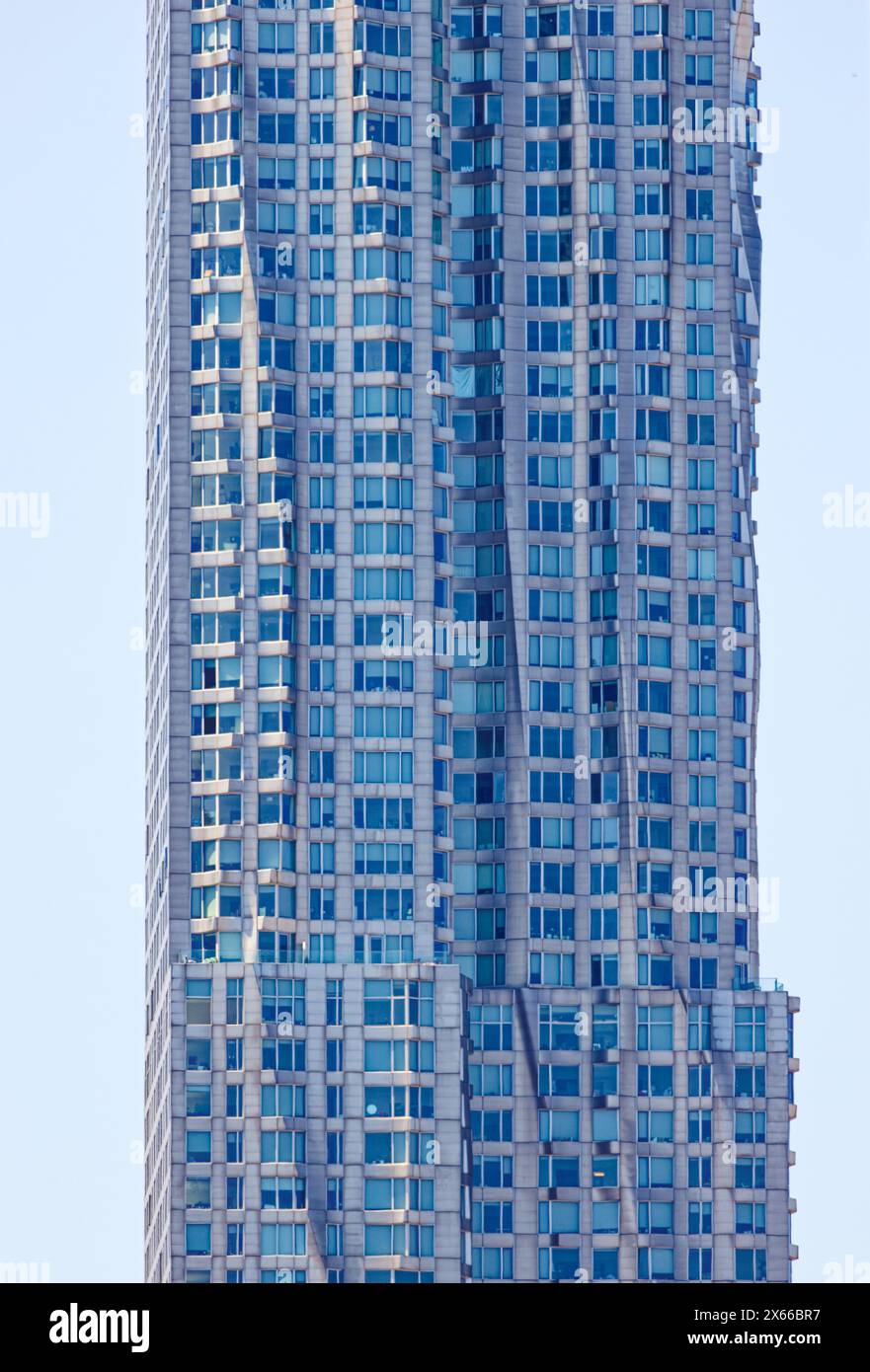 Façade detail of 8 Spruce Street, formerly known as New York By Gehry, a stainless-steel-clad residential tower in Lower Manhattan. Stock Photo