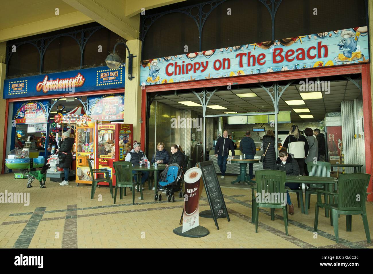 Amusement arcade and take away fish and chips shop in Whitmore Bay on Barry Island in Wales in early Spring Stock Photo