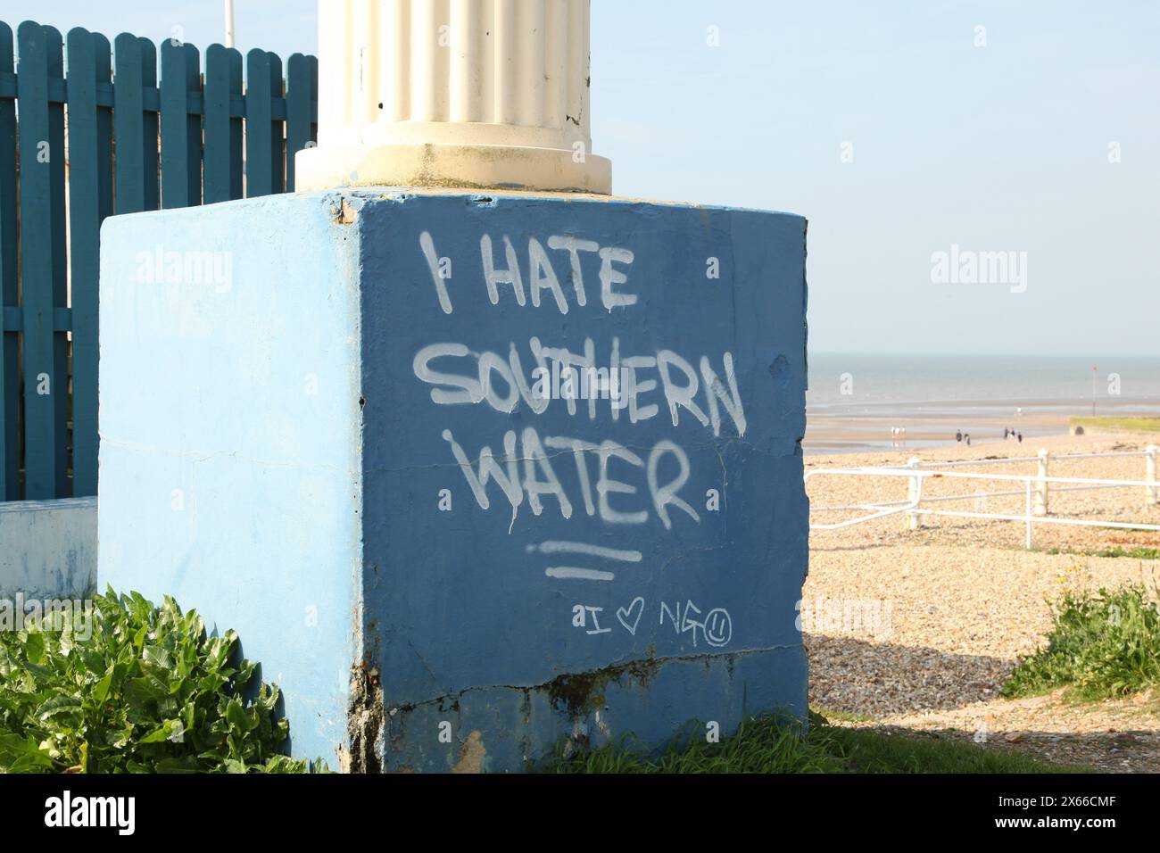 Graffiti "I hate Southern Water" painted on pillar at beach, St