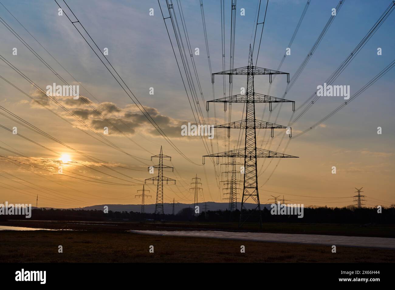 Symbolic image, energy crisis, power lines, at sunrise, Hesse, Germany Stock Photo