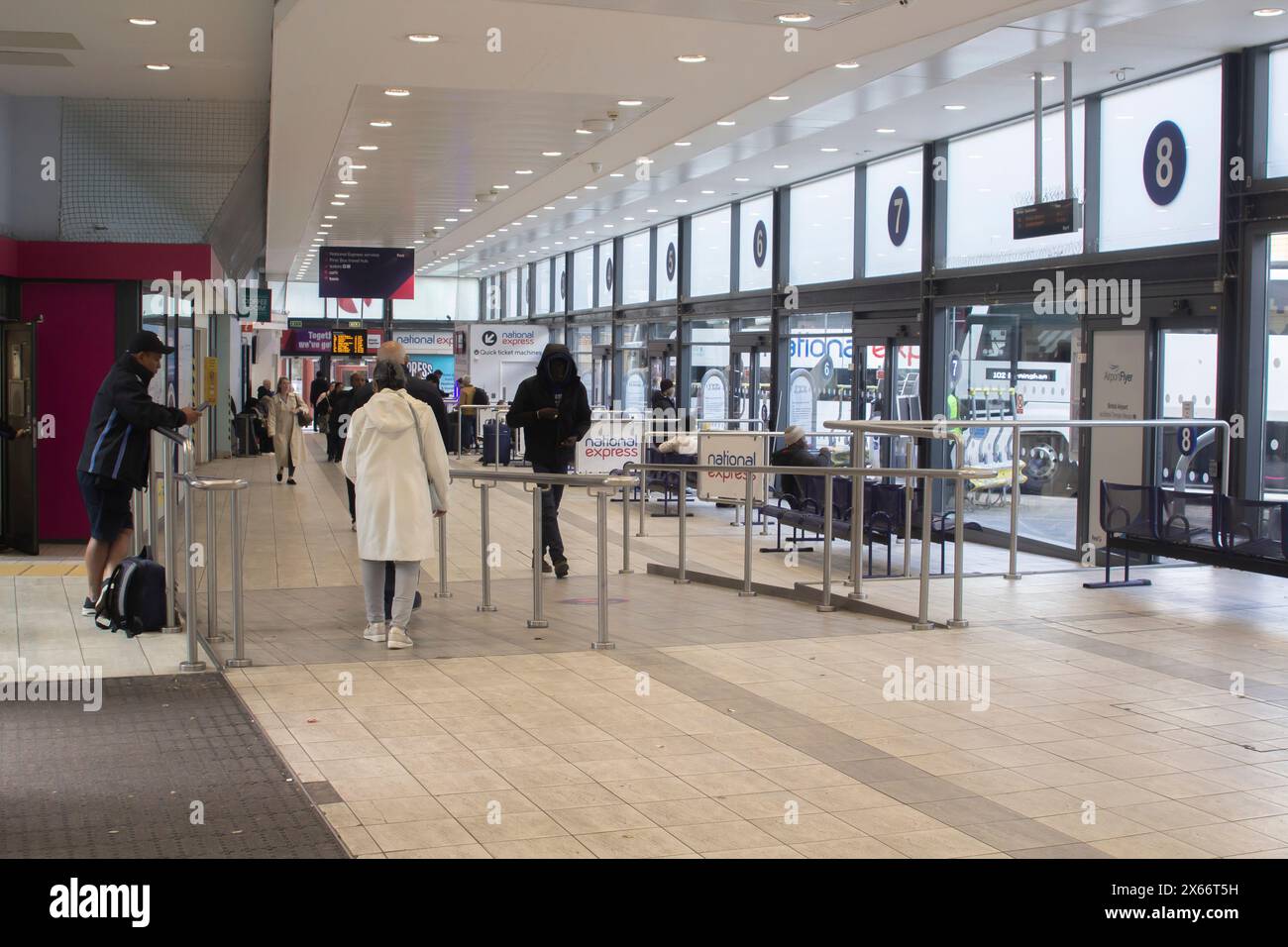 24 April 24 Commuters busying themselves in the modern Bristol Bus and Coach Station in Bristol Somerset in the South West of England Stock Photo