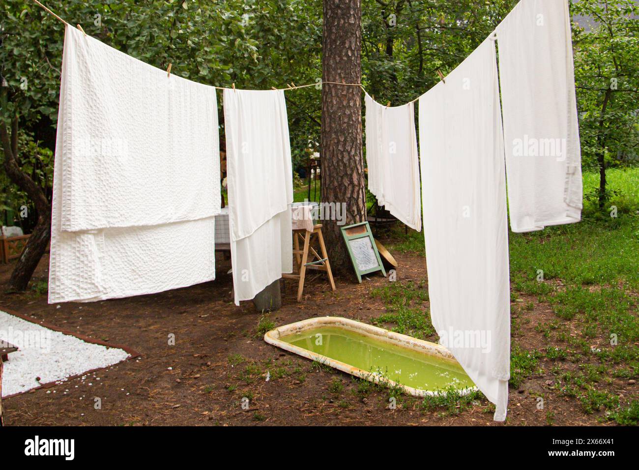 bed linen drying on a clothes line in the garden Stock Photo
