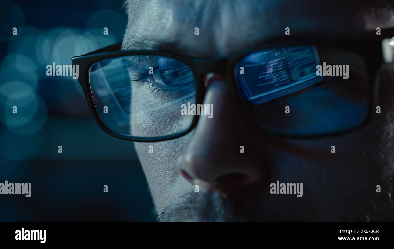 Close-up Portrait of Software Engineer Working on Computer, Line of Code Reflecting in Glasses. Developer Working on Innovative e-Commerce Application using Machine Learning, AI Algorithm, Big Data Stock Photo