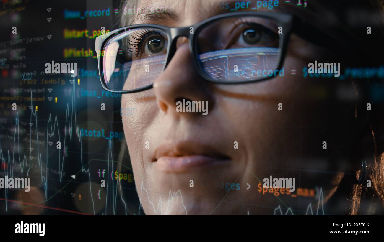 Close-up Portrait of Female Software Engineer Working on Computer, Program Code Run Aroung Her. Developer Working on Innovative e-Commerce Application using Machine Learning, AI, Big Data Stock Photo