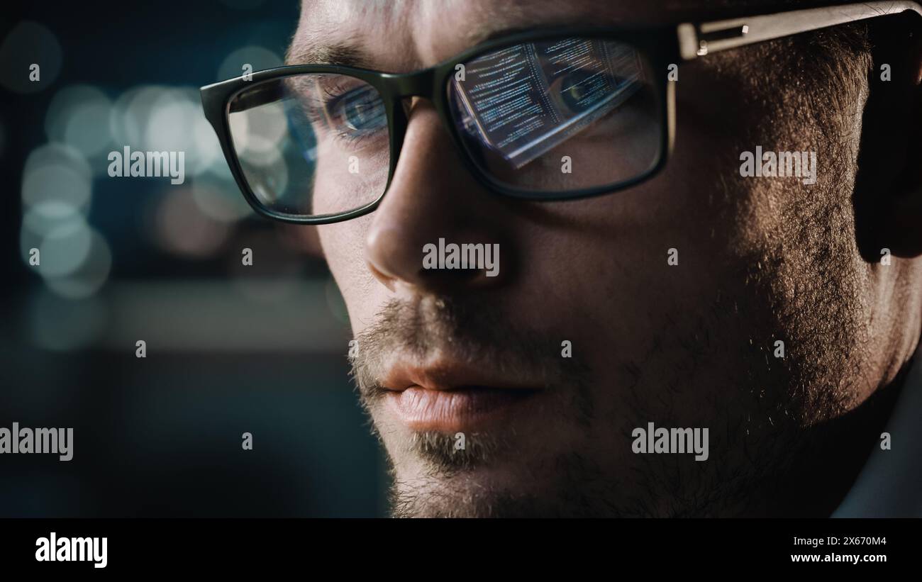 Close-up Portrait of Software Engineer Working on Computer, Line of Code Reflecting in Glasses. Developer Working on Innovative e-Commerce Application using Machine Learning, AI Algorithm, Big Data Stock Photo