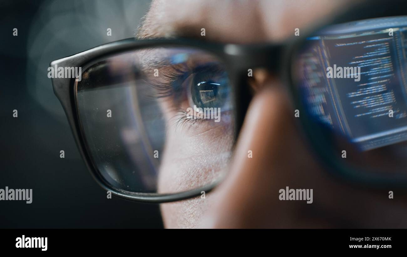 Close-up Portrait of Software Engineer Working on Computer, Line of Code Reflecting in Glasses. Developer Working on Innovative e-Commerce Application using Machine Learning, AI Algorithm, Big Data Stock Photo