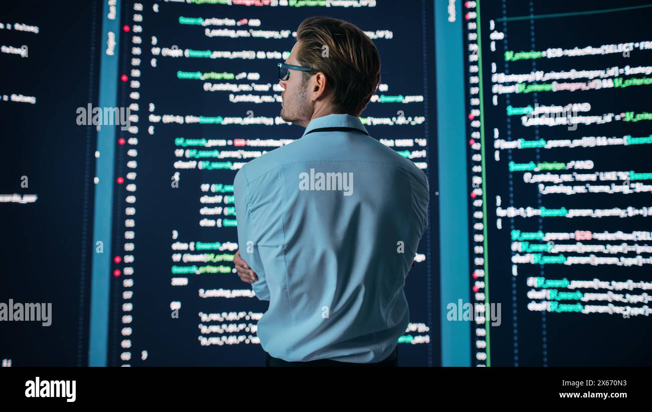 Innovative Startup: Portrait of Thoughtful Software Engineer Finding Solution, Planning Strategy, Doing Big Data Analysis. Screen Background. Programmer Developing e-Commerce App. Stock Photo
