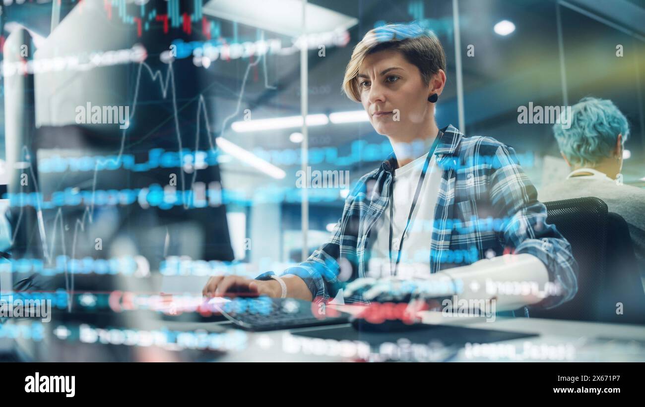 Shot with Visualisation of Running Computer Code on Foreground. Portrait of Motivated Woman with Disability Using Prosthetic Arm to Work on Computer in Body Positive Office. Myoelectric Bionic Hand Stock Photo